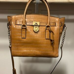 Authentic Michael Kors. A bit of wear on handle.